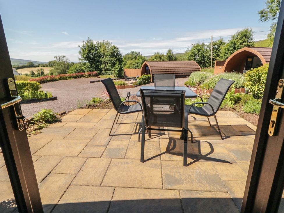 A patio area with a table and chairs at Gortin Glen Glamping Pod 2 Omagh