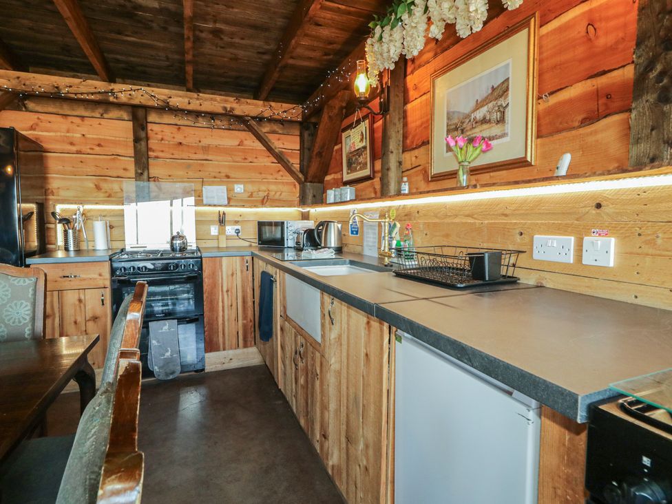 A kitchen with appliances and utensils at Gortin Glen Glamping Pod 2 in Omagh