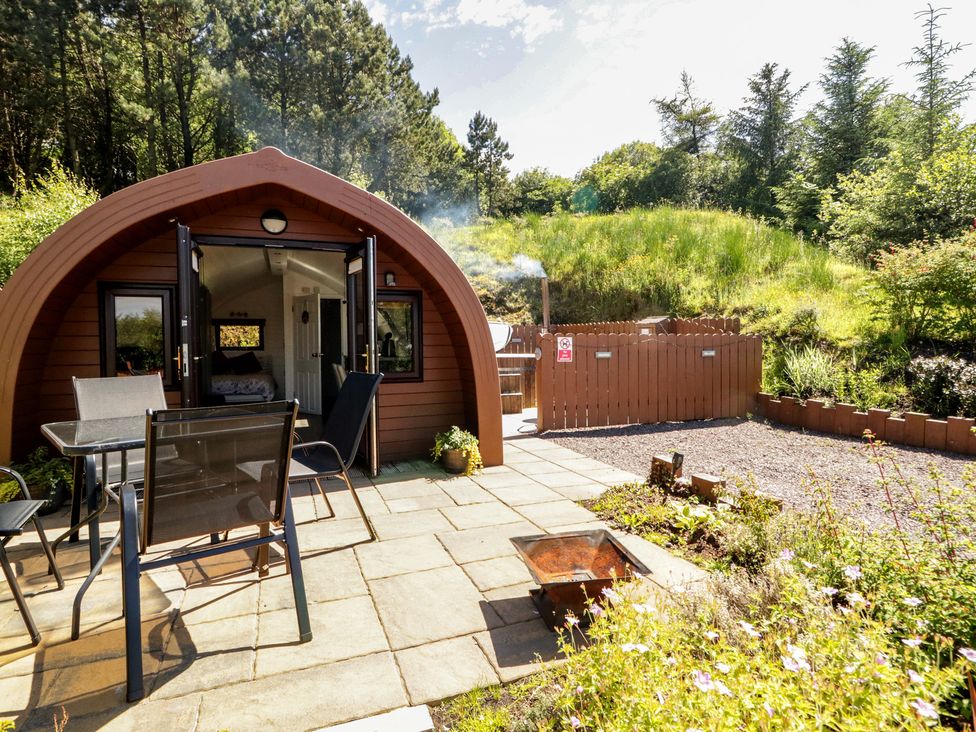 An outdoor area with a glamping pod and seating at Gortin Glen Glamping Pod 3 in Omagh