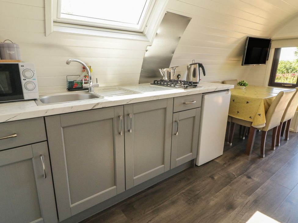 A kitchen with a sink and microwave at Gortin Glen Glamping Pod 3, Omagh