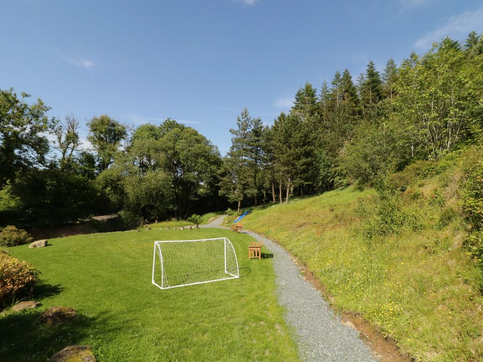 An outdoor area with a soccer goal and bench at Gortin Glen Glamping Pod 3 Omagh