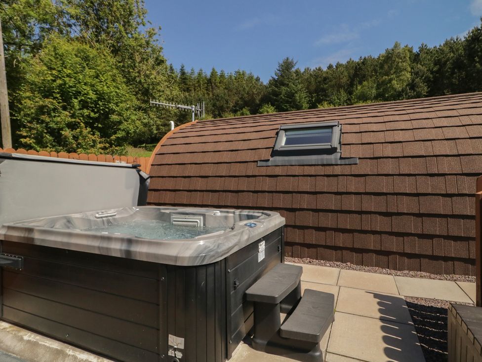 A hot tub with steps next to a building at Gortin Glen Glamping Pod 4 Omagh