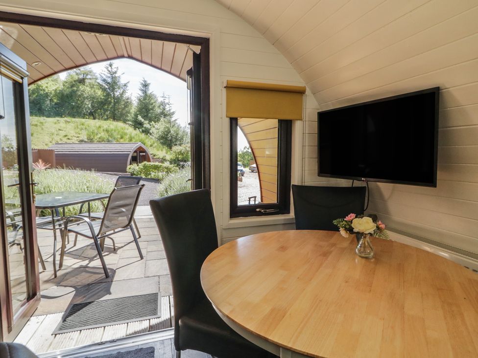 A dining area with a table and chairs at Gortin Glen Glamping Pod 5 Omagh