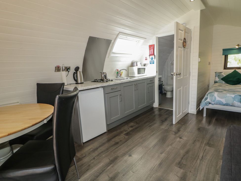A studio with kitchen and a bed at Gortin Glen Glamping Pod 5 Omagh