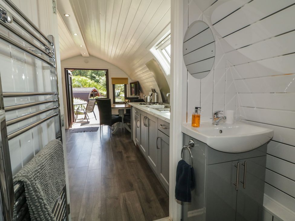 A bathroom with a sink and towel radiator at Gortin Glen Glamping Pod 5 Omagh