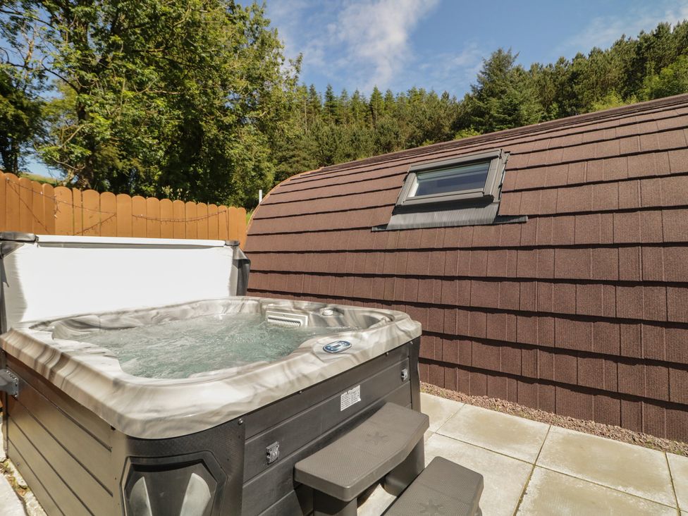 An outdoor space with a hot tub and a brown roof at Gortin Glen Glamping Pod 5 in Omagh