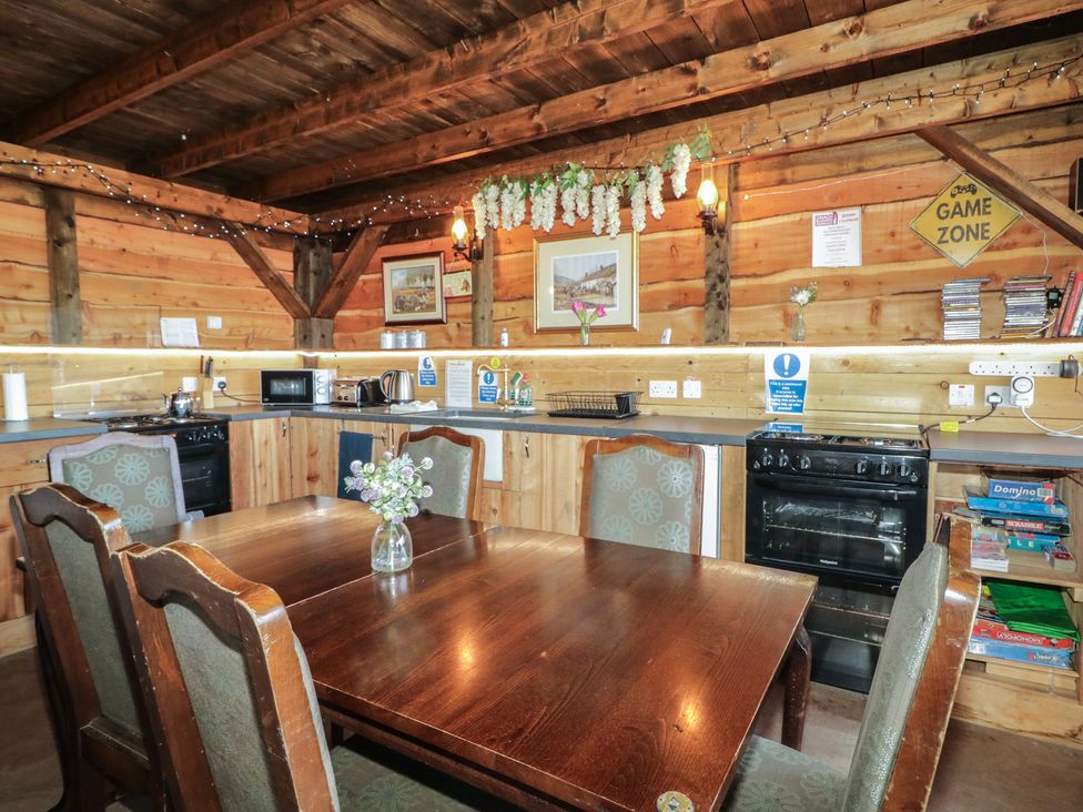 A kitchen with a dining table and kitchen appliances at Gortin Glen Glamping Pod 5 in Omagh