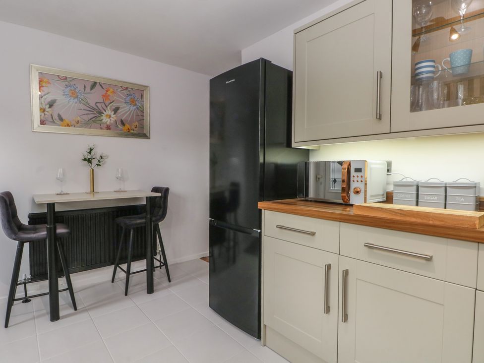 A kitchen with a refrigerator and microwave at Coastal Cottage in Lytham St. Annes