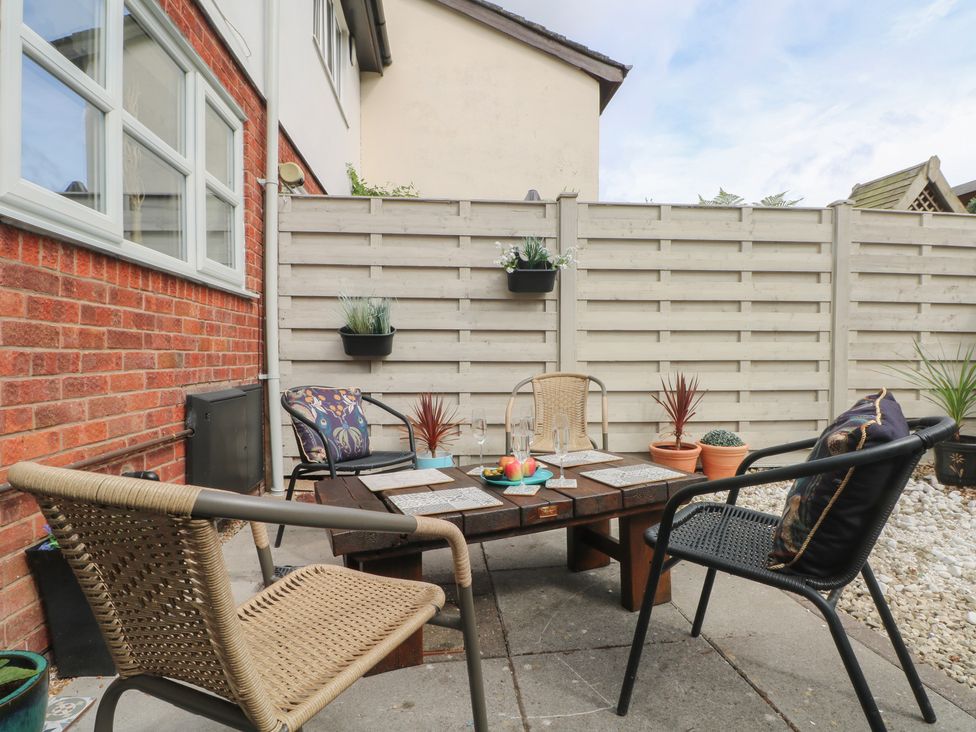 An outdoor patio with a table and chairs at Coastal Cottage in Lytham St. Annes