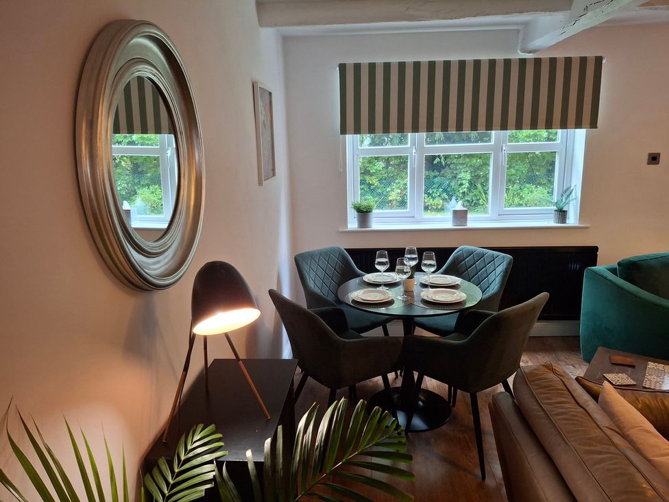 A dining area with table and chairs at Coastal Cottage in Lytham St. Annes
