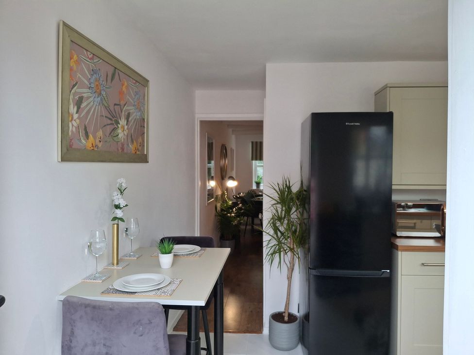 A kitchen with a dining table and chairs at Coastal Cottage in Lytham St. Annes