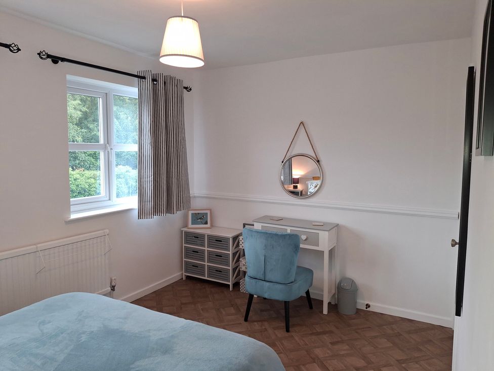 A bedroom with a desk and a chair beside a window at Coastal Cottage in Lytham St. Annes
