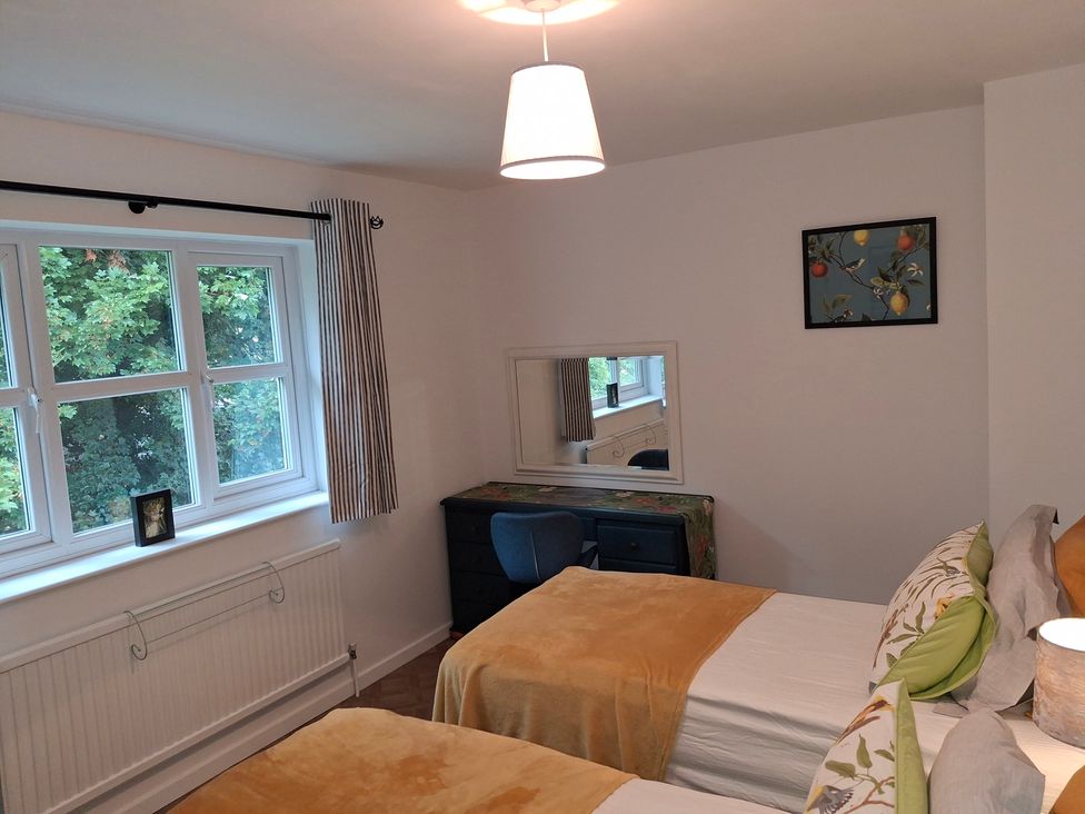 A bedroom with two beds and a desk at Coastal Cottage in Lytham St. Annes