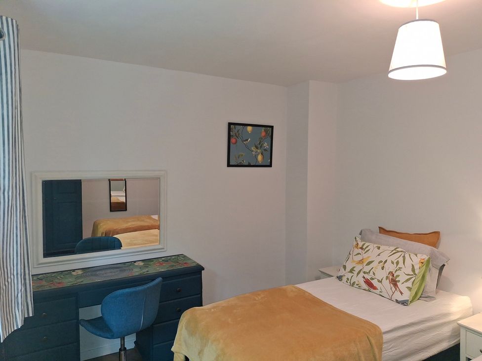 A bedroom with a bed and desk at Coastal Cottage in Lytham St. Annes
