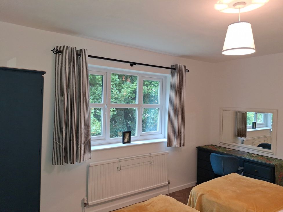 A bedroom with a window and dresser at Coastal Cottage in Lytham St. Annes