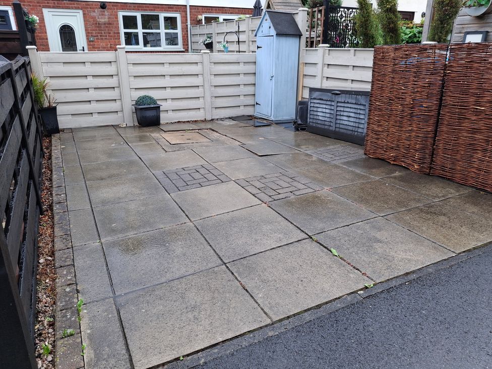 An outdoor paved area with a shed and storage boxes at Coastal Cottage in Lytham St. Annes