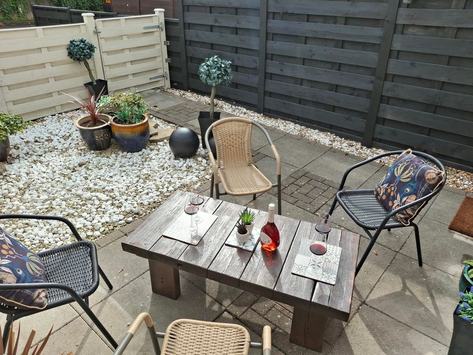 A patio with a table and chairs at Coastal Cottage in Lytham St. Annes