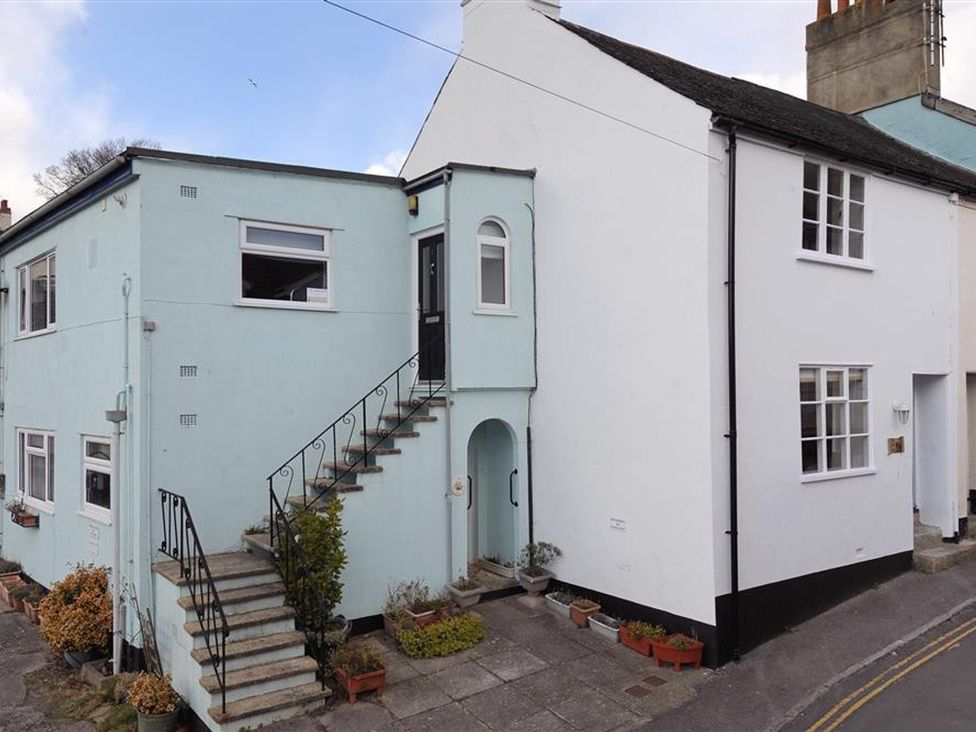 An exterior view of a building with stairs and planters at 2 Mill Green Court Lyme Regis