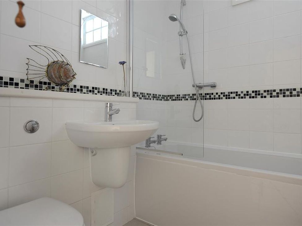 A bathroom with a shower and bathtub at 2 Mill Green Court in Lyme Regis