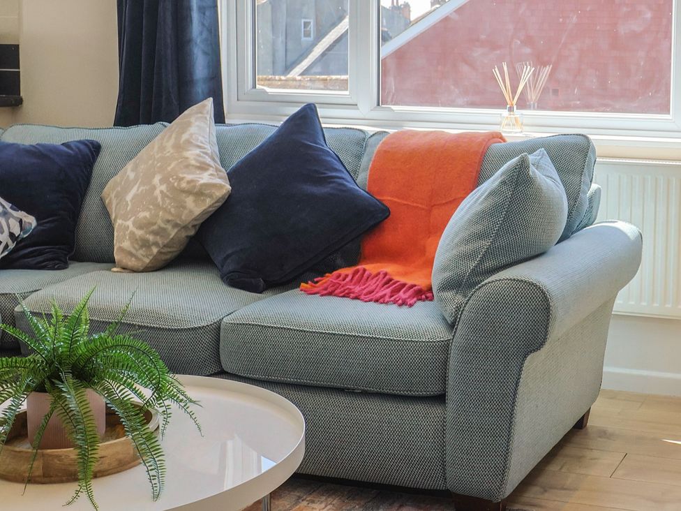 A living room with a sofa and table at 2 Mill Green Court in Lyme Regis