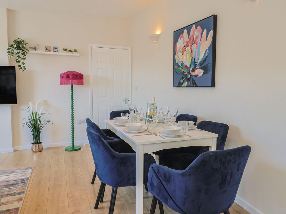 A dining room with a table set for meals at 2 Mill Green Court Lyme Regis