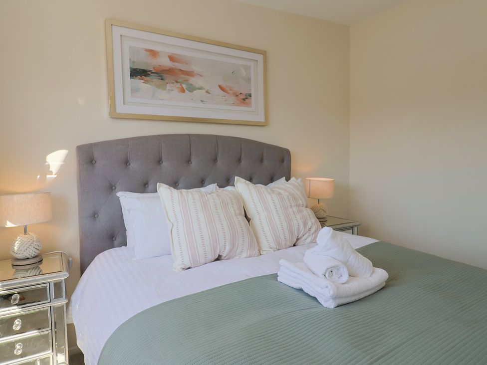 A bedroom with a bed and pillows at 2 Mill Green Court Lyme Regis