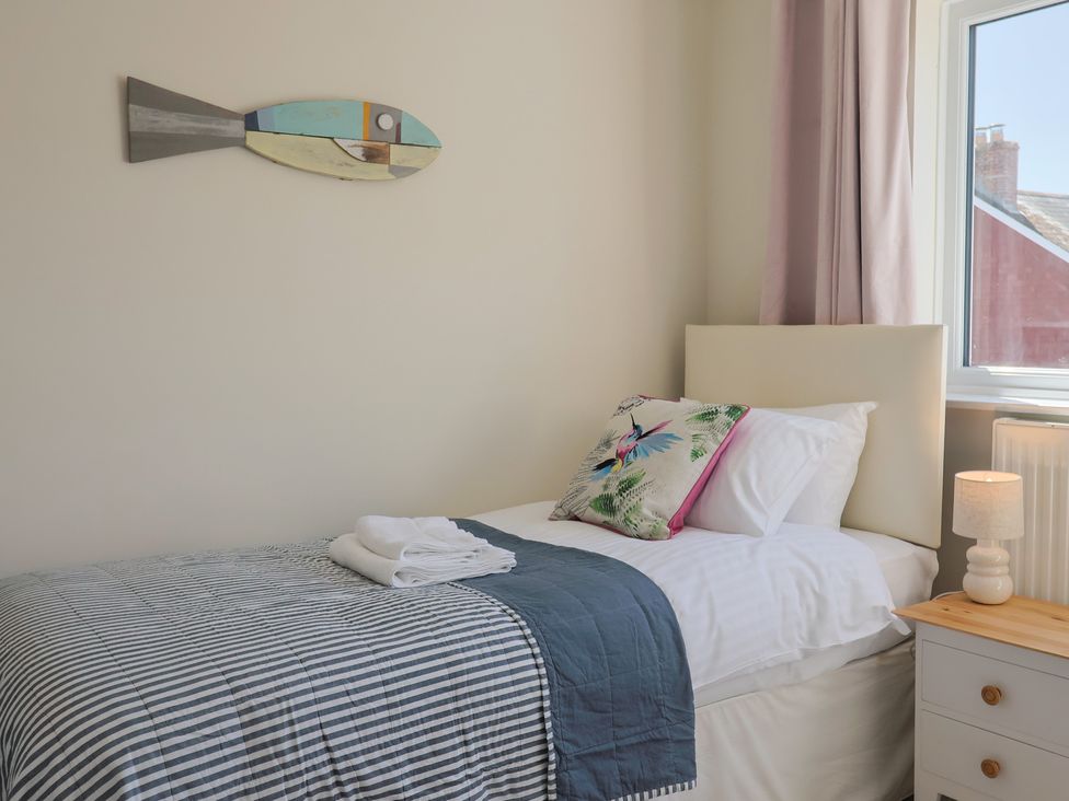 A bedroom with a single bed and lamp at 2 Mill Green Court in Lyme Regis