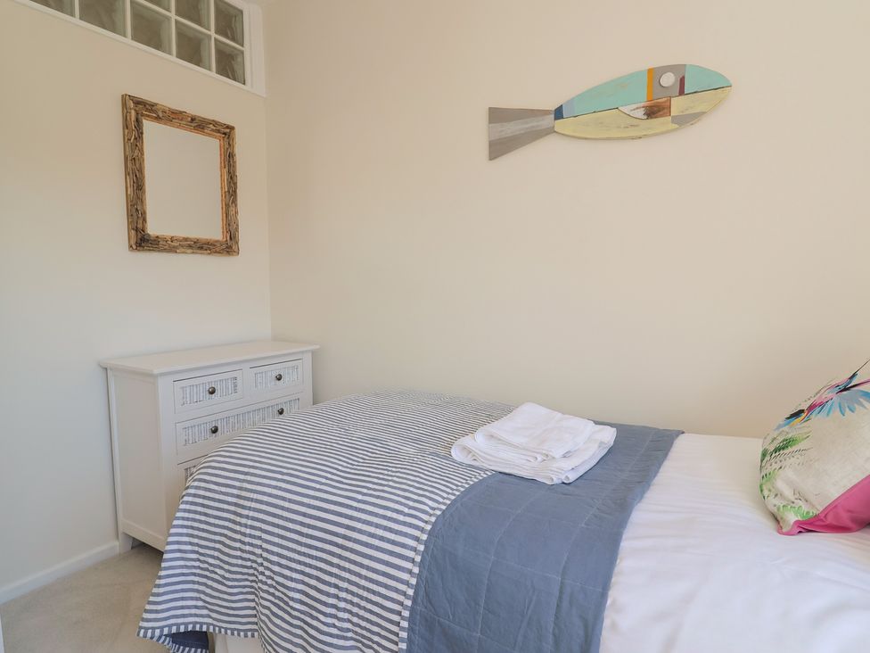 A bedroom with a bed and dresser at 2 Mill Green Court Lyme Regis