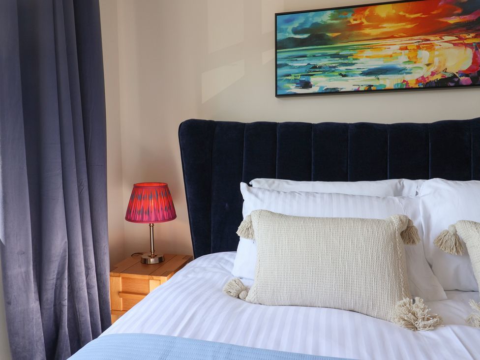 A bedroom with a bed and bedside lamp at 2 Mill Green Court in Lyme Regis