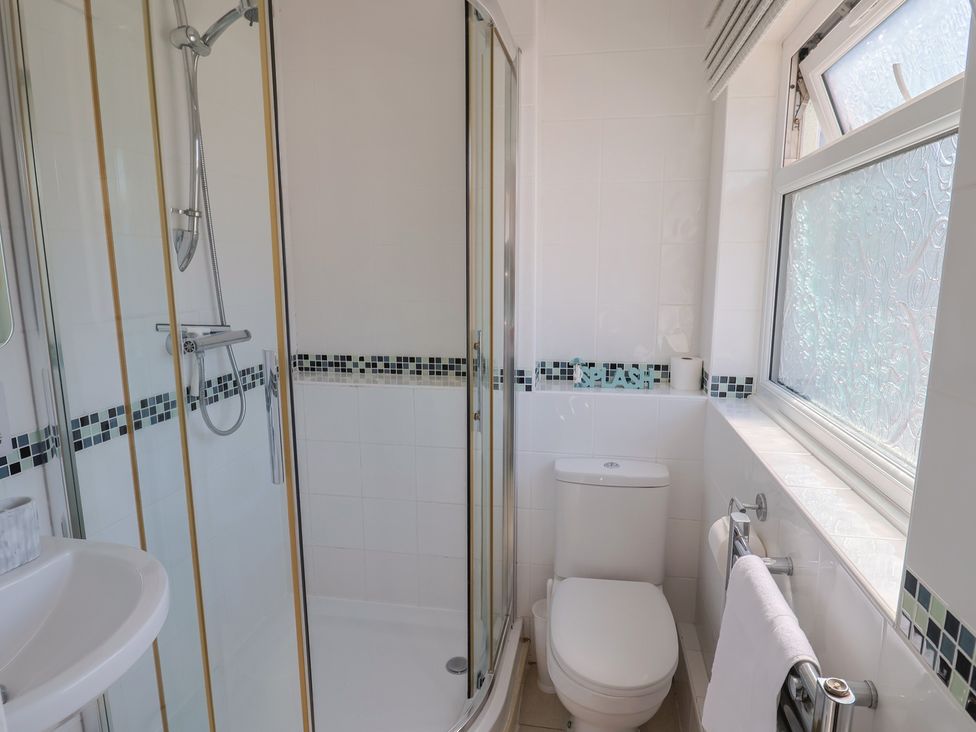 A bathroom with a shower and toilet at 2 Mill Green Court Lyme Regis