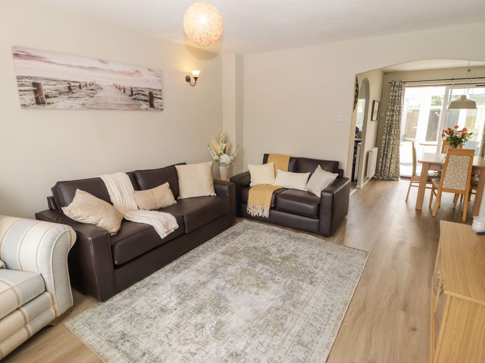 A living room with a sofa and a dining table at 7 Cwrt Y Cadno Llantwit Major