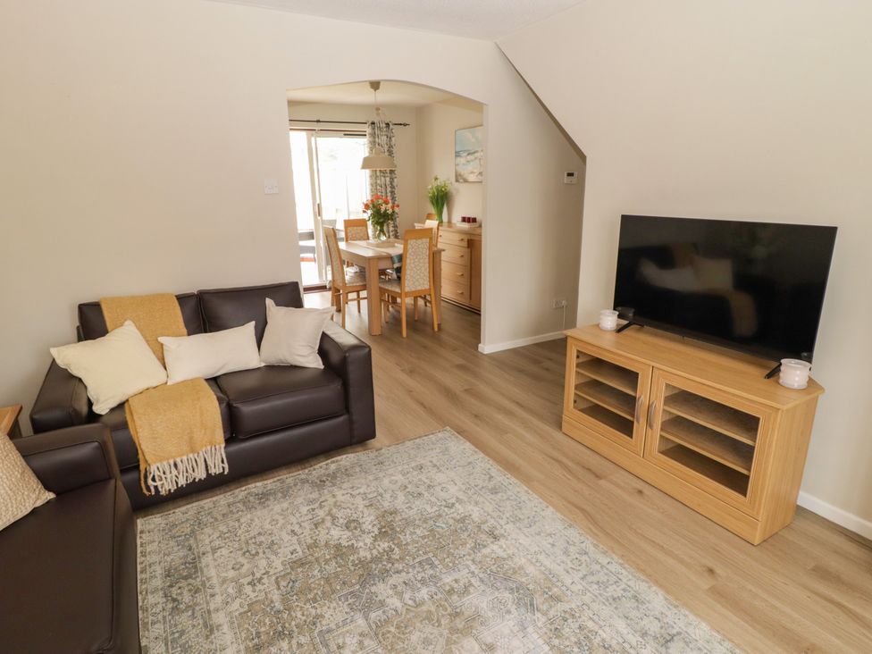 A living room with a sofa and television at 7 Cwrt Y Cadno Llantwit Major