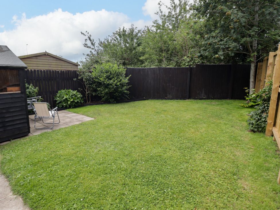 A garden with grass and a shed at 7 Cwrt Y Cadno in Llantwit Major