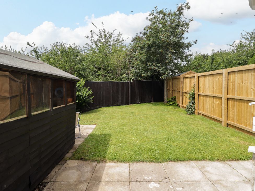 A garden with a shed and grass at 7 Cwrt Y Cadno in Llantwit Major