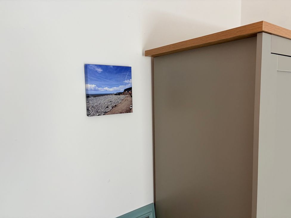 A photo on a wall near a cabinet at 7 Cwrt Y Cadno in Llantwit Major