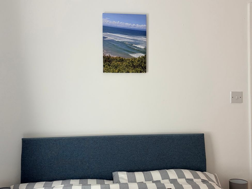A bedroom with a bed and picture on the wall at 7 Cwrt Y Cadno in Llantwit Major