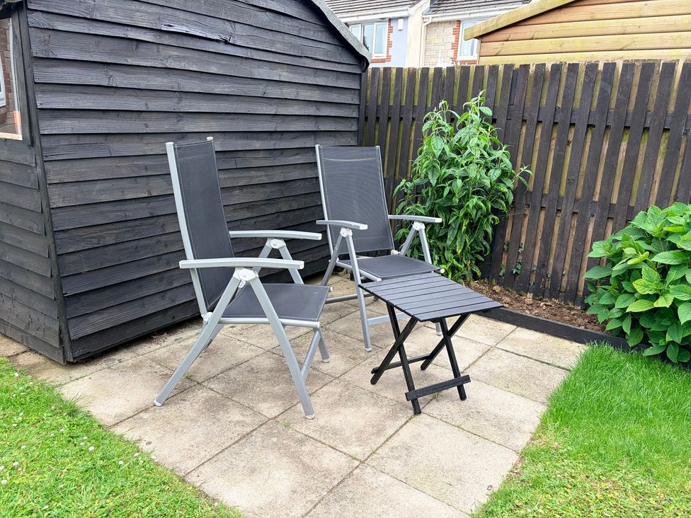A garden area with chairs and a shed at 7 Cwrt Y Cadno Llantwit Major
