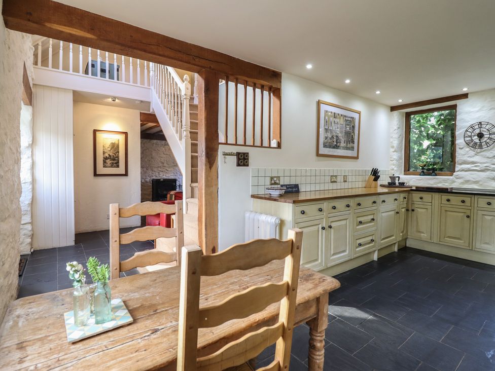 A kitchen with a table and chairs at Pandy Farmhouse