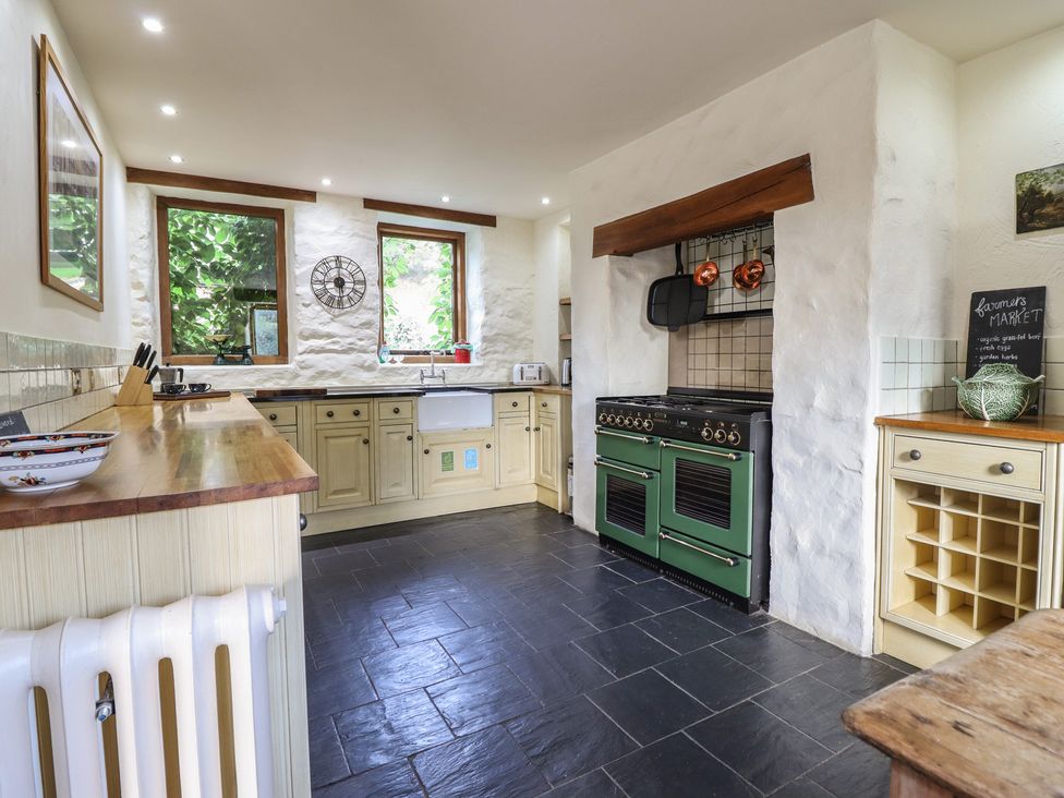 A kitchen with cooking range and sink at Pandy Farmhouse