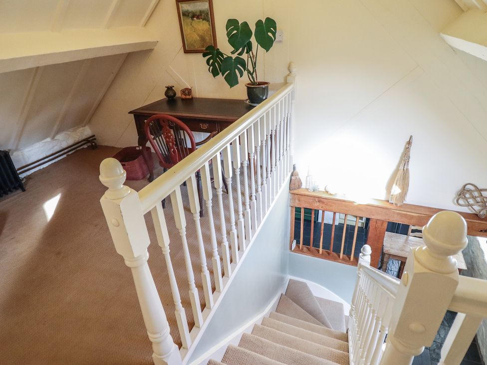 A staircase view with a desk and plant at Pandy Farmhouse