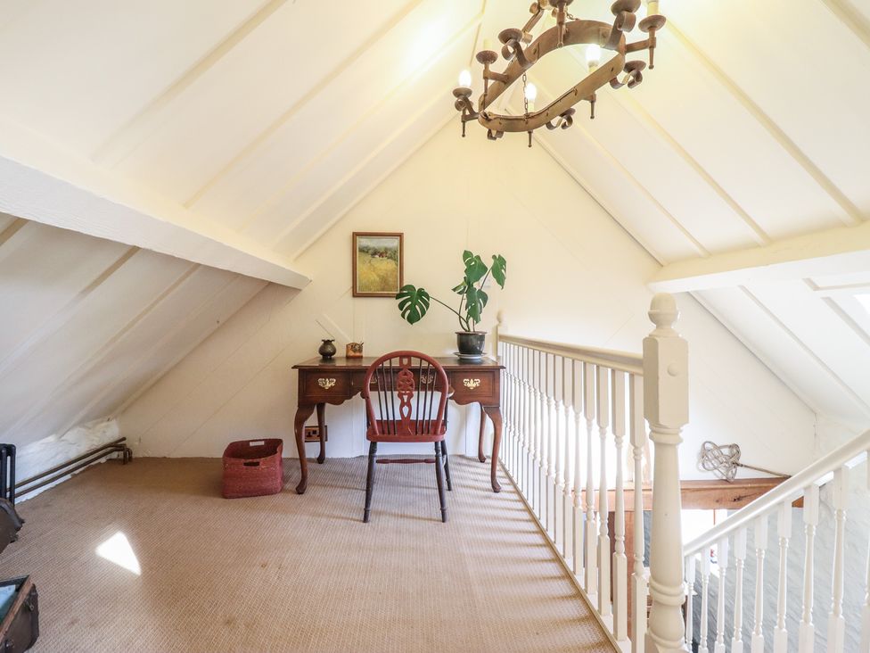 A landing with a desk and chair at Pandy Farmhouse