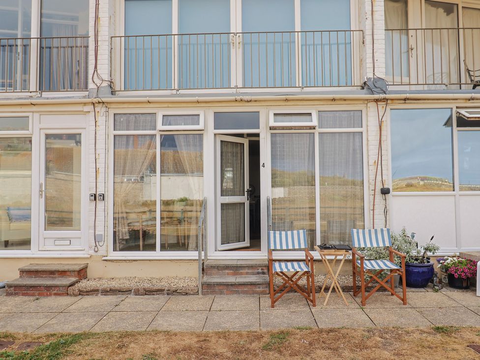 An outdoor area with chairs and a table at 4 Kingfisher Court in West Bay