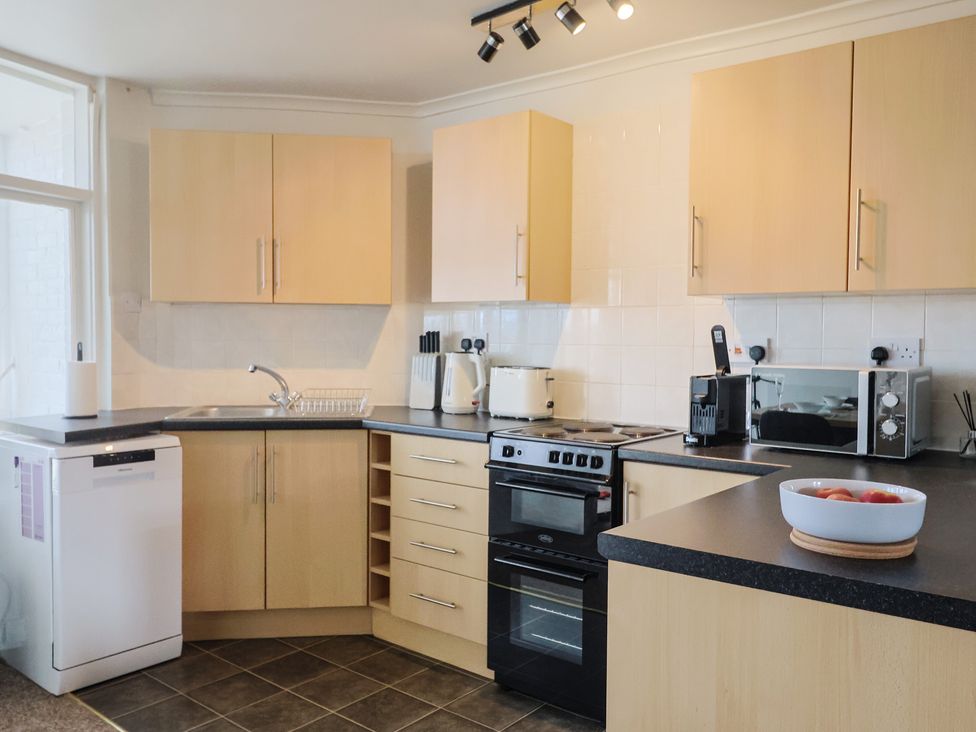 A kitchen with cabinets and appliances at 4 Kingfisher Court West Bay