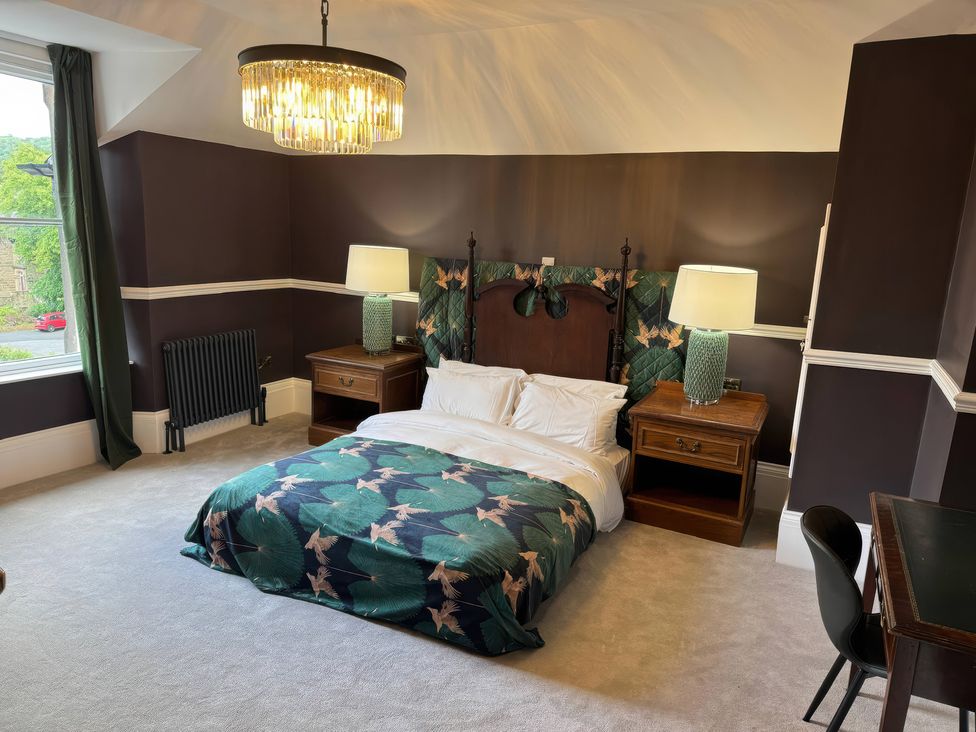 A bedroom with a bed and side tables at The Buxton Suite in Buxton