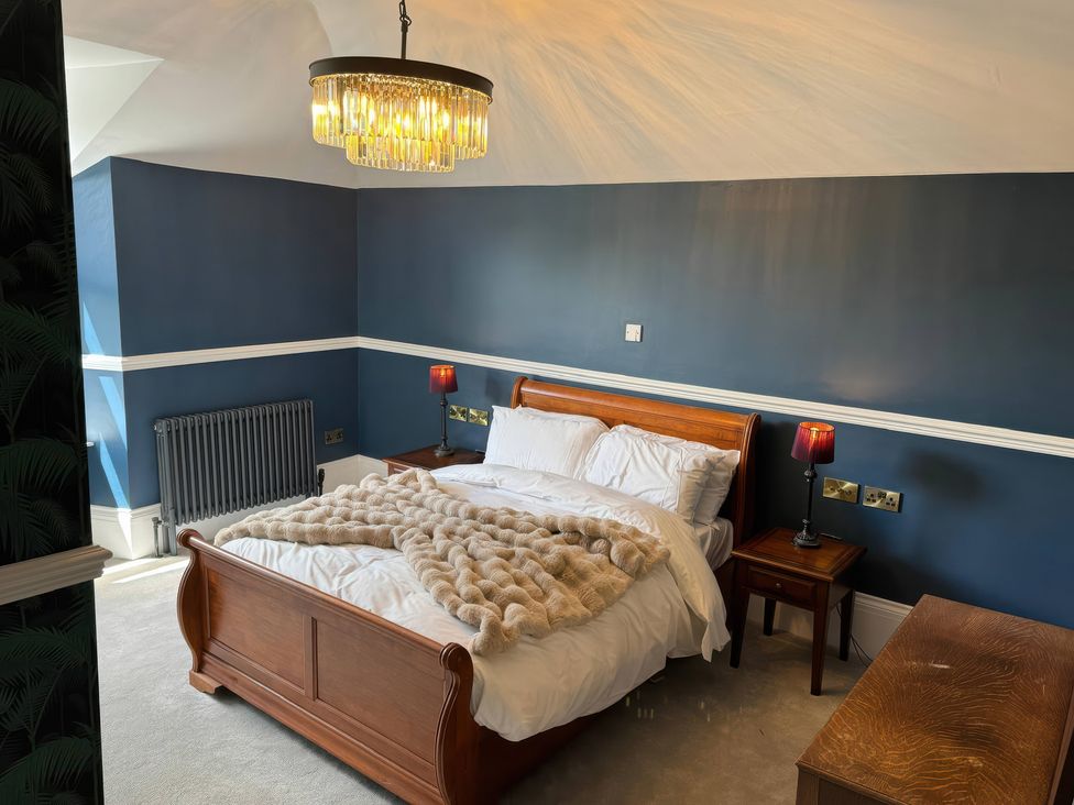A bedroom with a bed and bedside tables at The Buxton Suite in Buxton