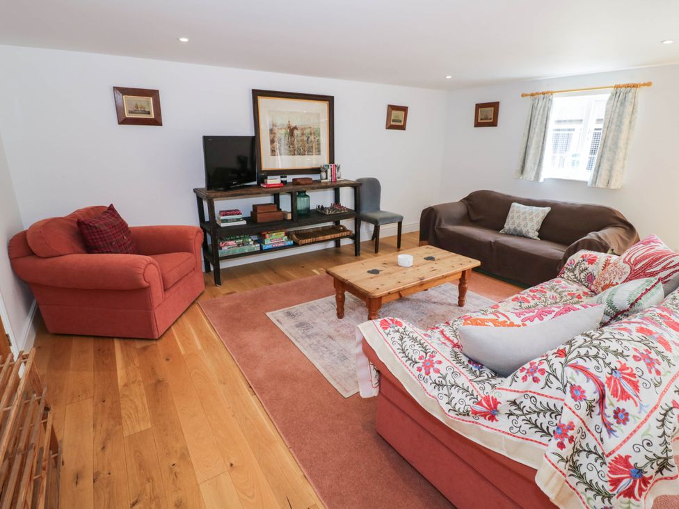 A living room with a sofa and coffee table at Wayside in Moreton-in-Marsh