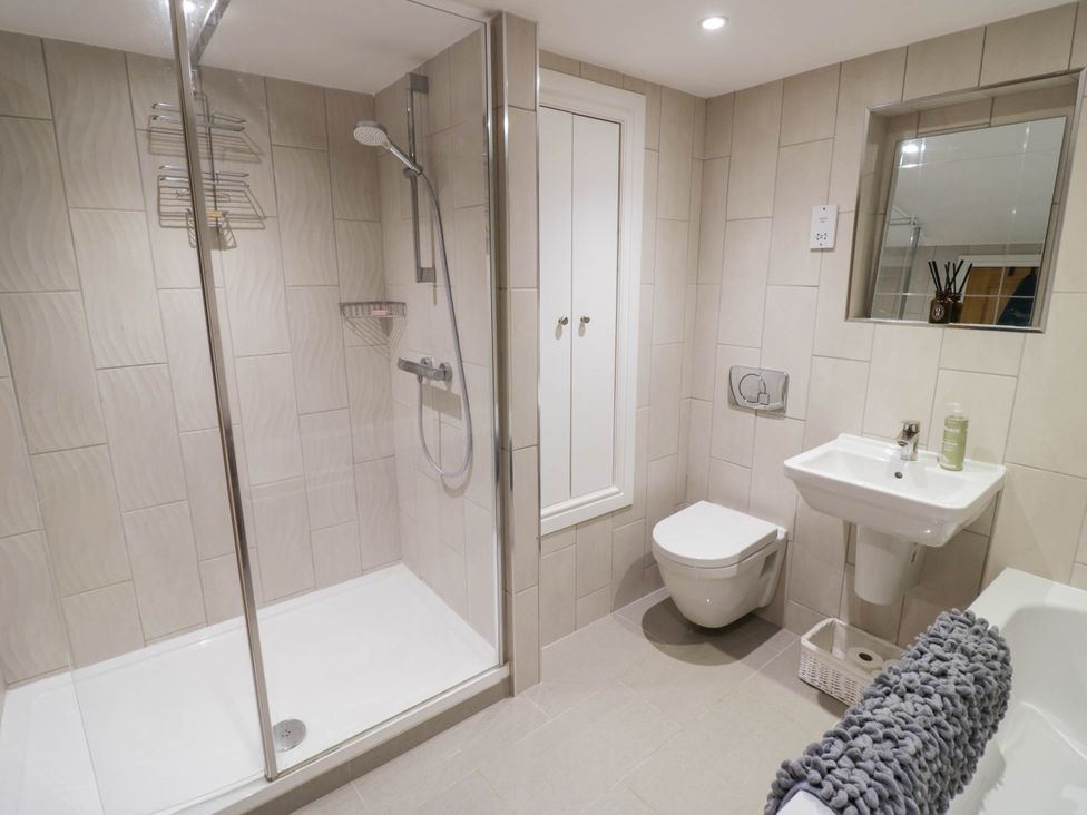 A bathroom with a shower, toilet, and sink at Wayside in Moreton-in-Marsh