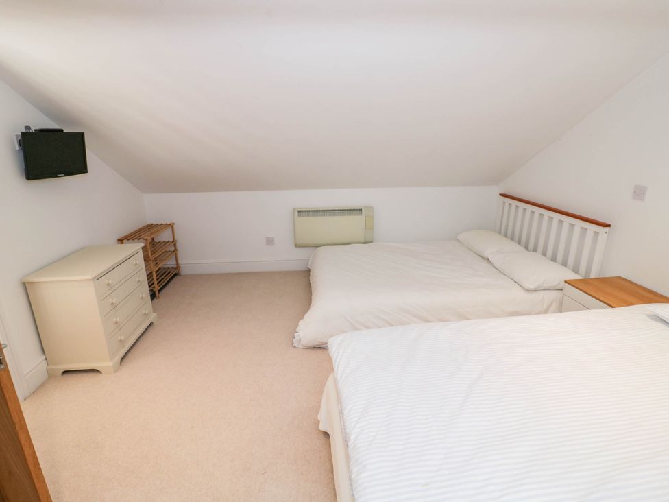 A bedroom with two beds and a dresser at Wayside Moreton-in-Marsh