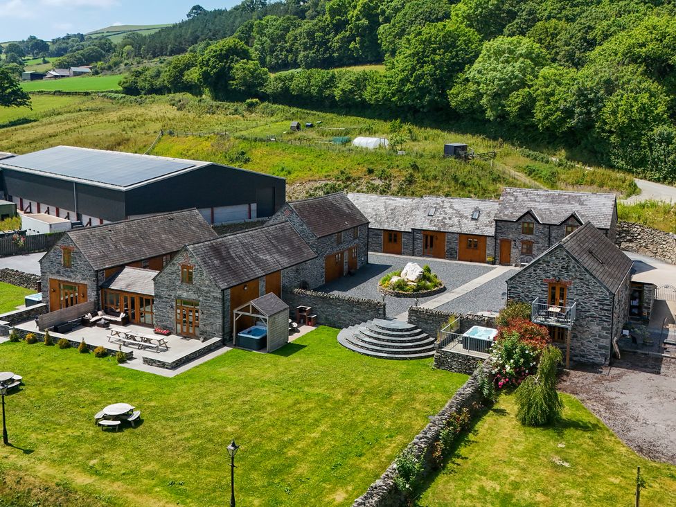 An outdoor area with buildings and seating at The Granary in Corwen