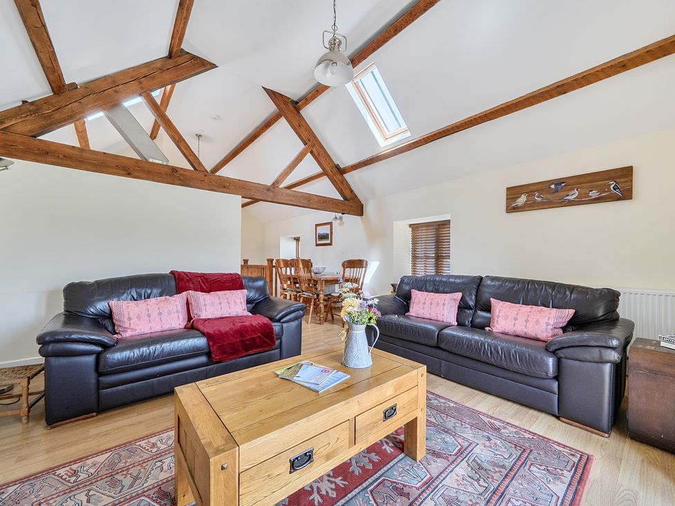 A living room with sofas and a coffee table at The Granary in Corwen